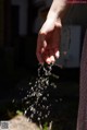 A person's hand is pouring water from a fountain.