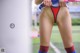 A woman in a red and blue thong on a soccer field.