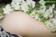 A close up of a woman's butt with white flowers on it.