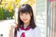 A young woman in a school uniform posing for a picture.