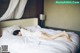 A woman laying on a bed in a hotel room.